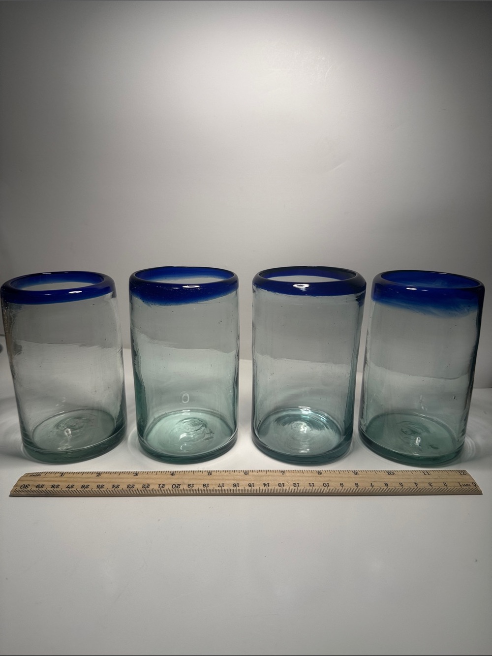 Four Mexican hand blown clear and cobalt blue rimmed drinking glasses